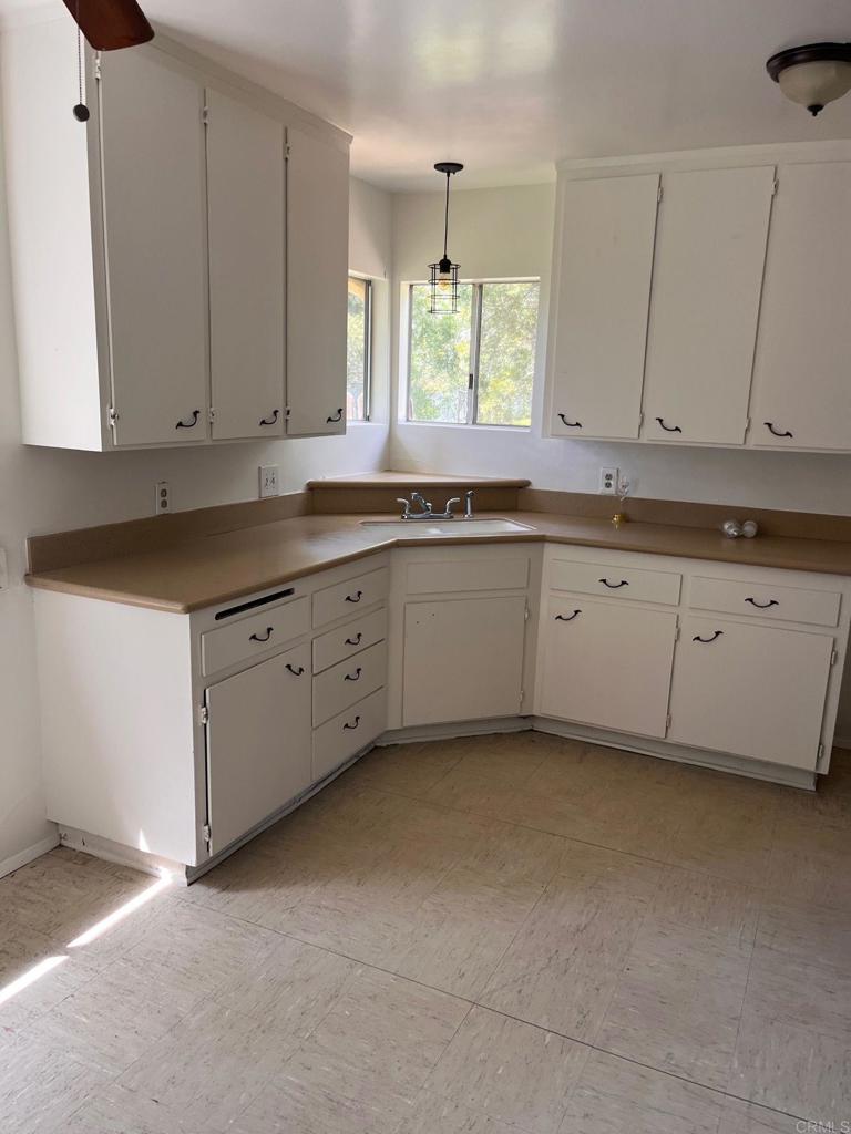 2005-07 Camino Rainbow Fallbrook, CA 92028 - Photo 42 of 65 a kitchen with granite countertop white cabinets and a sink