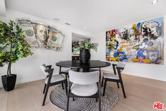 a view of a dining room with furniture and a potted plant