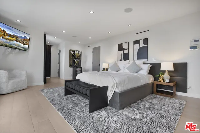 a spacious bedroom with a large bed and a couch