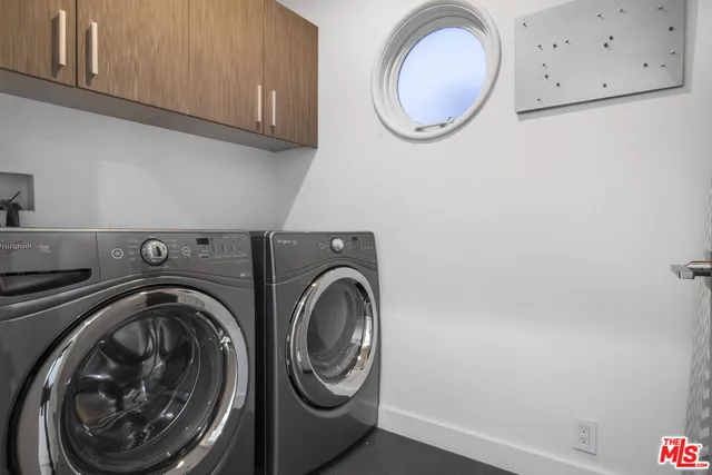 a view of storage and utility room with washer and dryer
