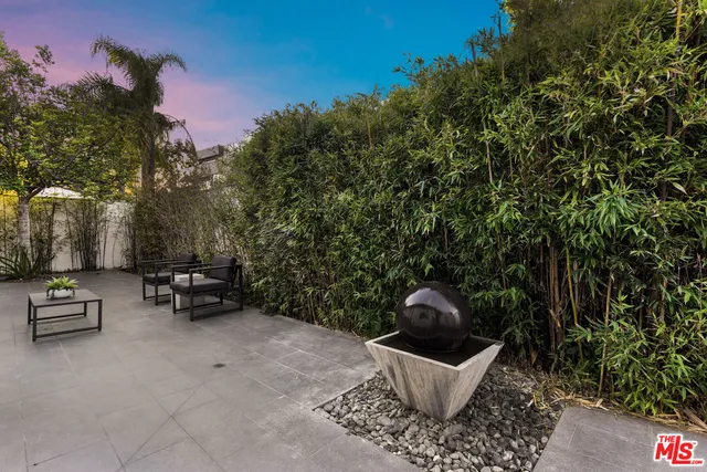 a view of a chairs and tables in the back yard of the house