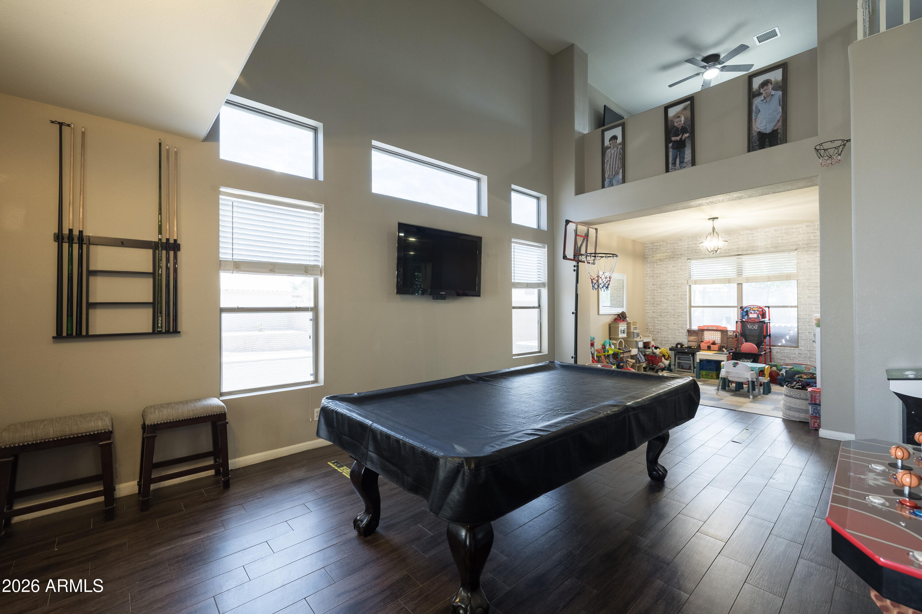 6407 West Saddlehorn Road Phoenix, AZ 85083 - Photo 15 of 41 a living room with furniture pool table wooden floor and windows
