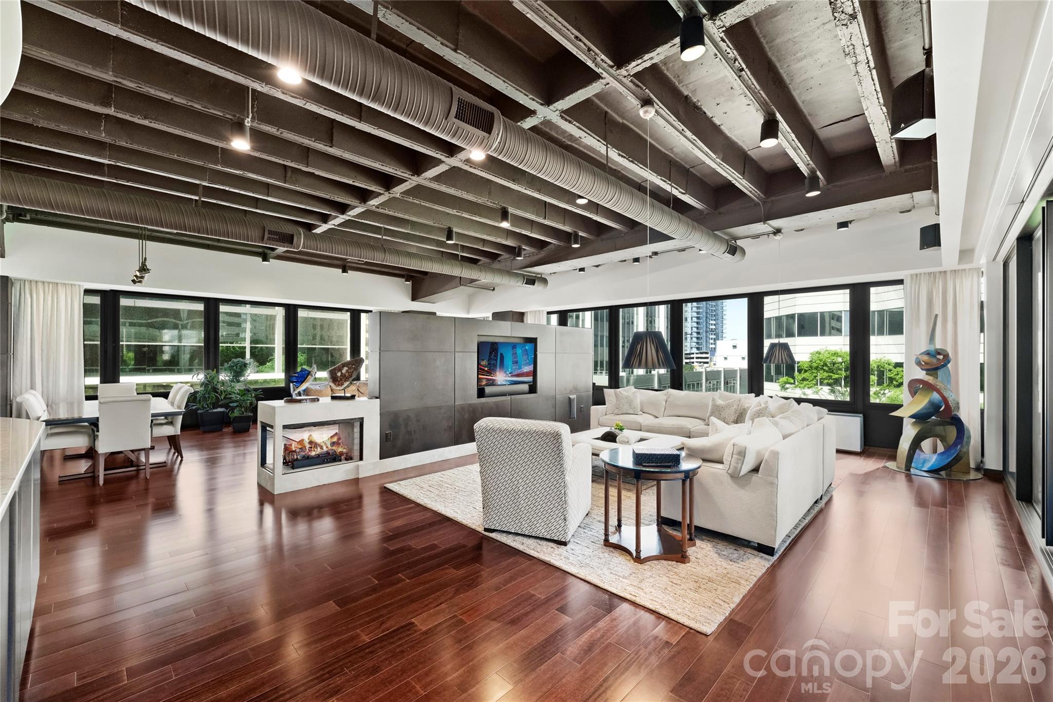 139 South Tryon Street, Unit 6 Charlotte, NC 28202 - Photo 12 of 47 a view of a livingroom with furniture wooden floor and a chandelier