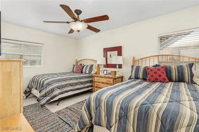 a bedroom with two beds and a window