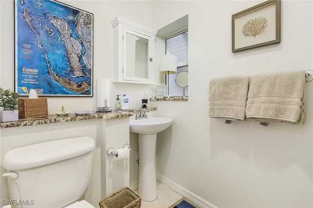 a bathroom with a sink mirror vanity and toilet