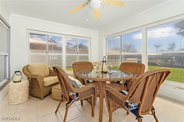 a view of a dining room with furniture a chandelier and wooden floor