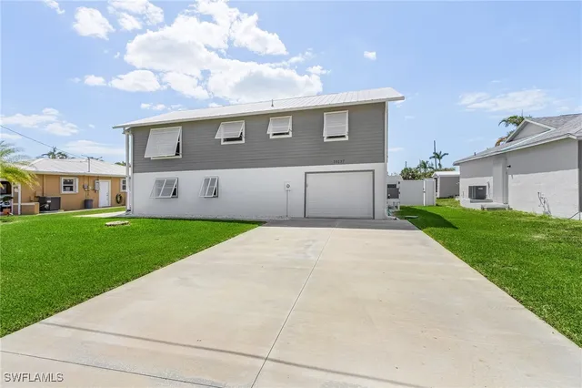a front view of a house with a yard and garage