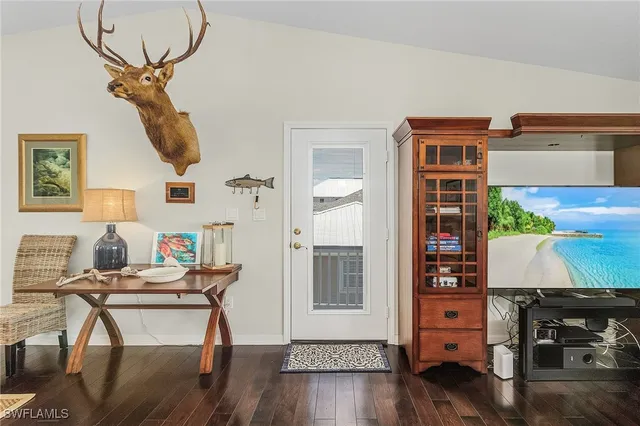 a view of a room with furniture and wooden floor