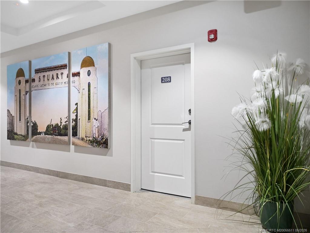 41 Southwest Seminole Street, Unit 208 Stuart, FL 34994 - Photo 43 of 46 a view of a hallway with paintings on the wall