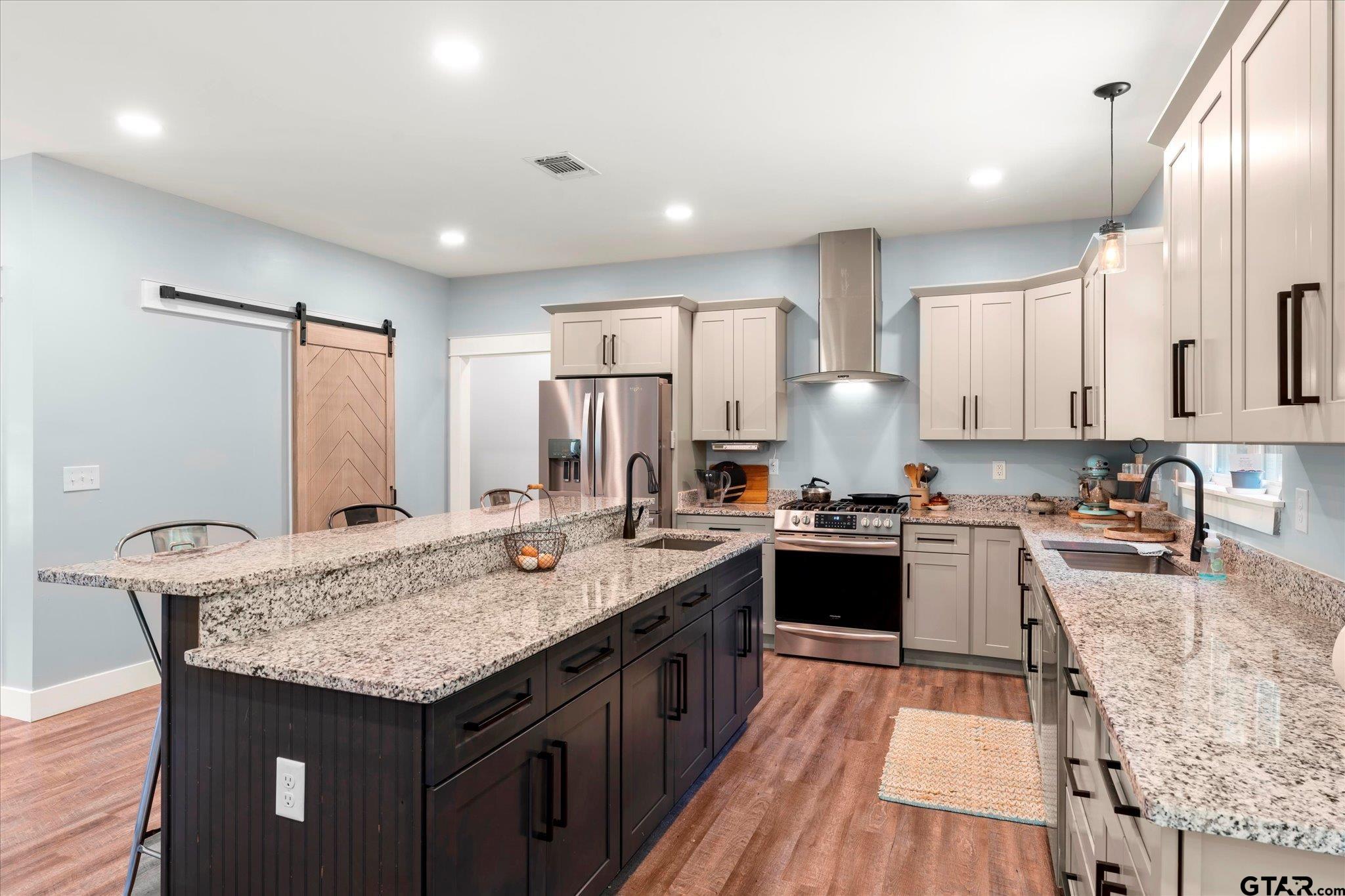 1663 County Road 4510 Pittsburg, TX 75686 - Photo 13 of 34 a kitchen with granite countertop kitchen island a sink stove and refrigerator