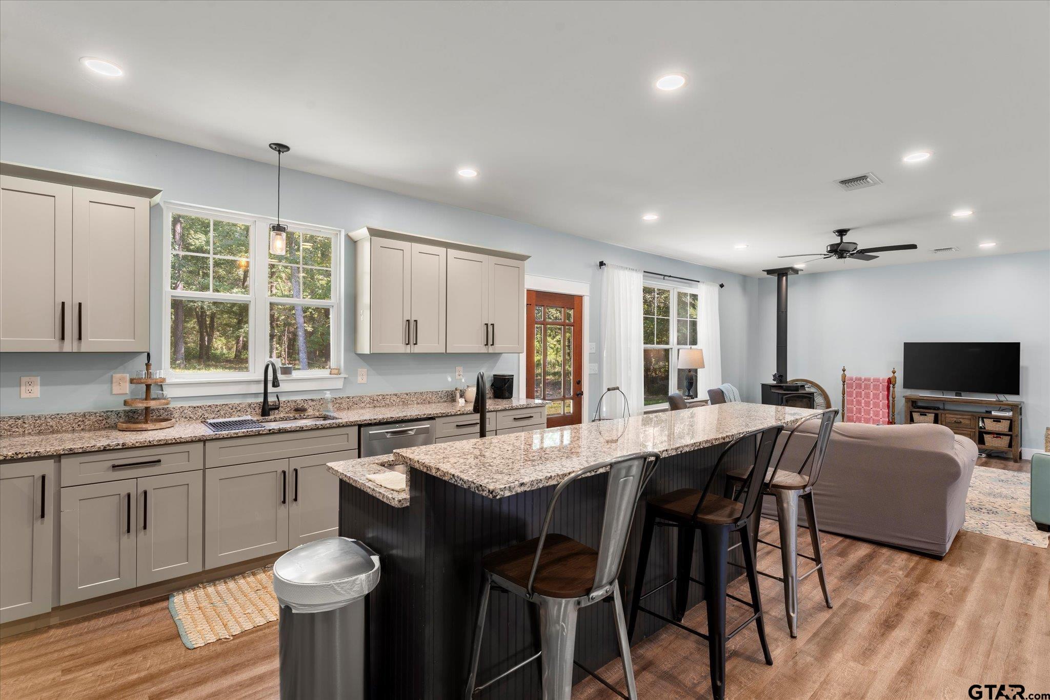 1663 County Road 4510 Pittsburg, TX 75686 - Photo 17 of 34 a large kitchen with lots of counter space a sink and dining table