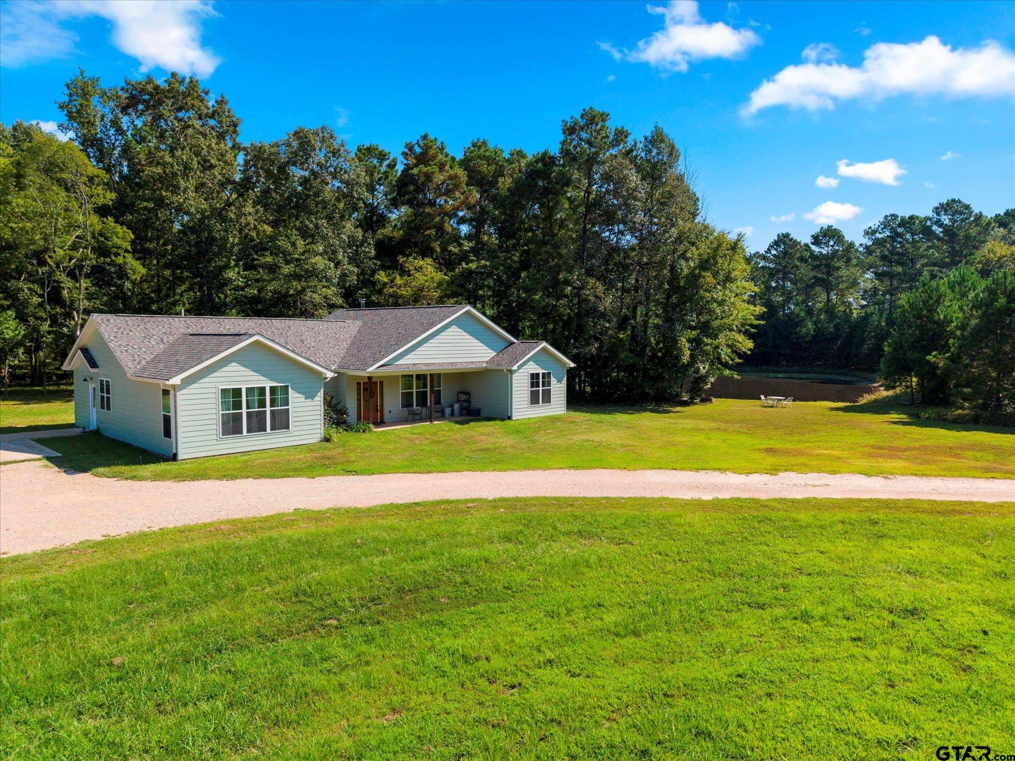 1663 County Road 4510 Pittsburg, TX 75686 - Photo 2 of 34 a front view of house with yard and green space