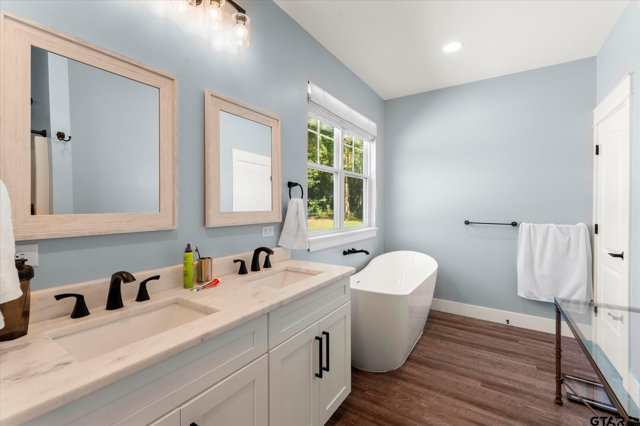 1663 County Road 4510 Pittsburg, TX 75686 - Photo 23 of 34 a bathroom with a toilet sink and mirror