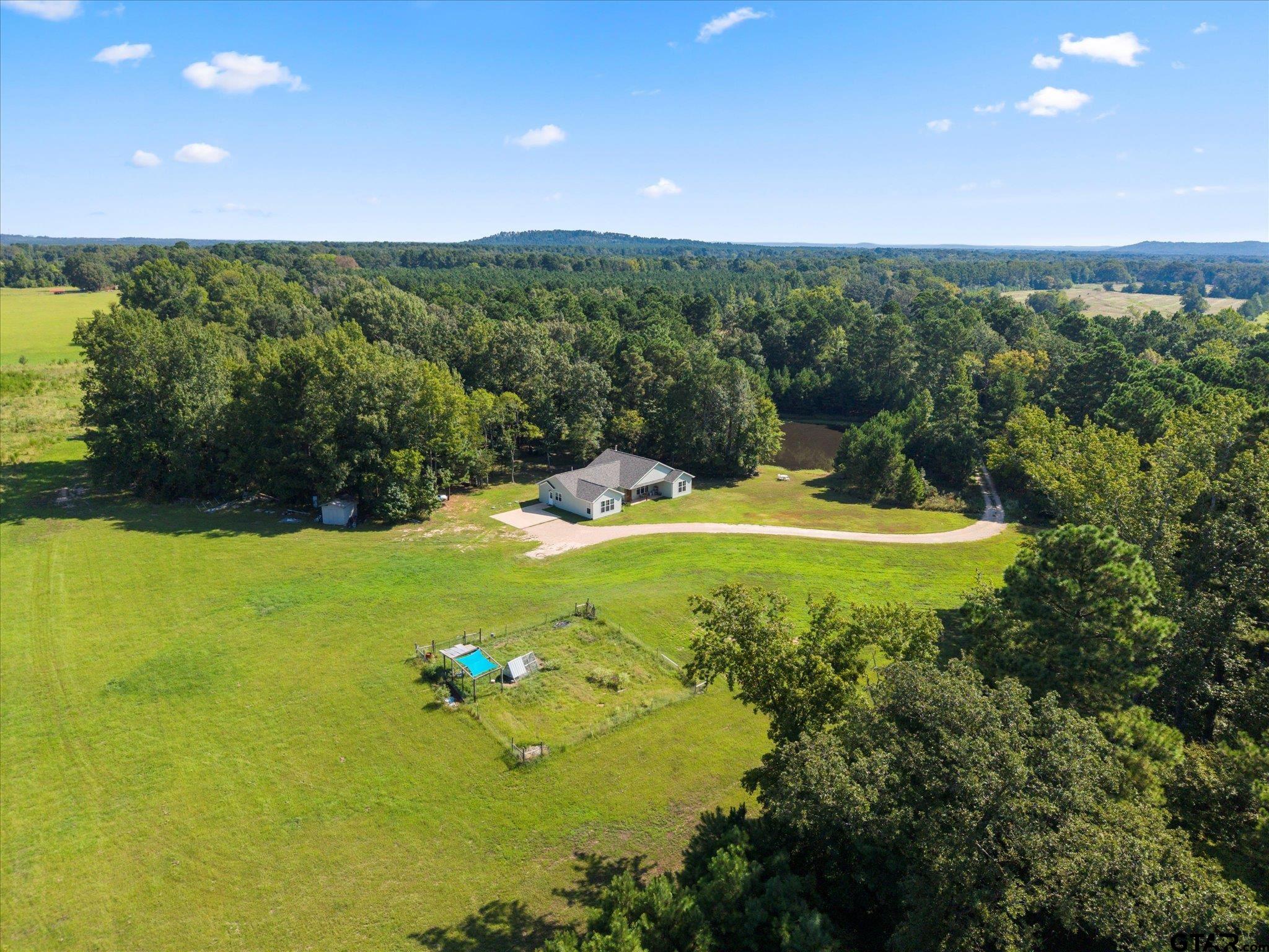 1663 County Road 4510 Pittsburg, TX 75686 - Photo 6 of 34 a view of a lake with a yard