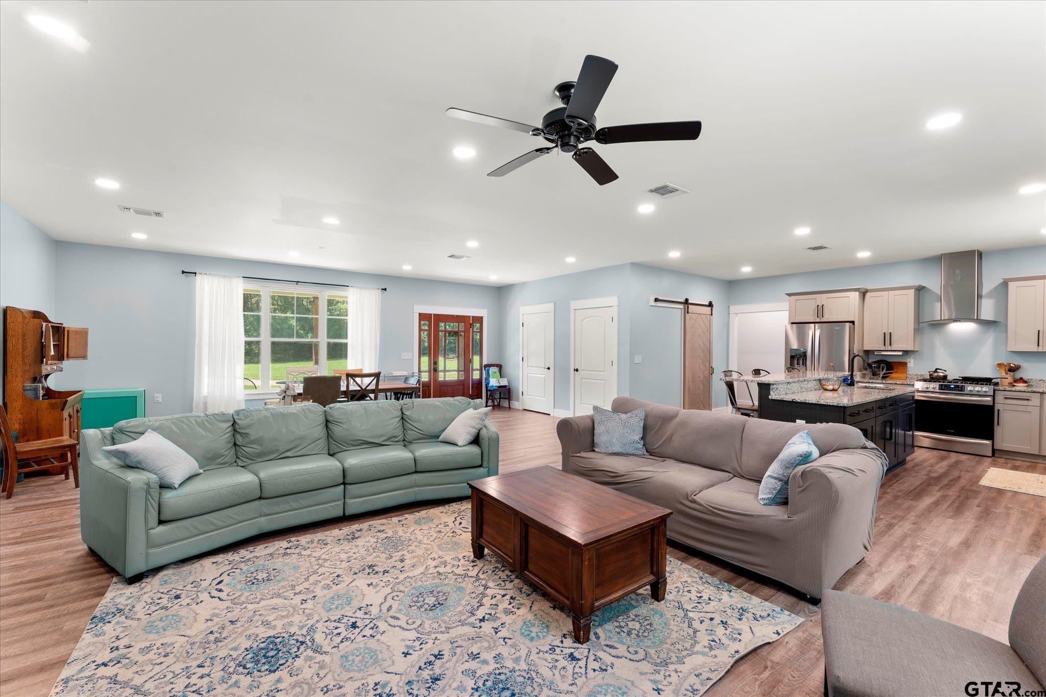 1663 County Road 4510 Pittsburg, TX 75686 - Photo 8 of 34 a living room with furniture and a ceiling fan