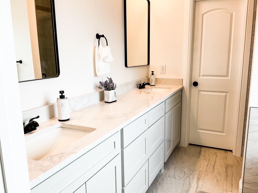 201 Bluff Court Godley, TX 76044 - Photo 12 of 17 a bathroom with a sink and a mirror