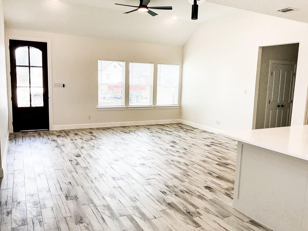 201 Bluff Court Godley, TX 76044 - Photo 6 of 17 a view of a livingroom with wooden floor and a window