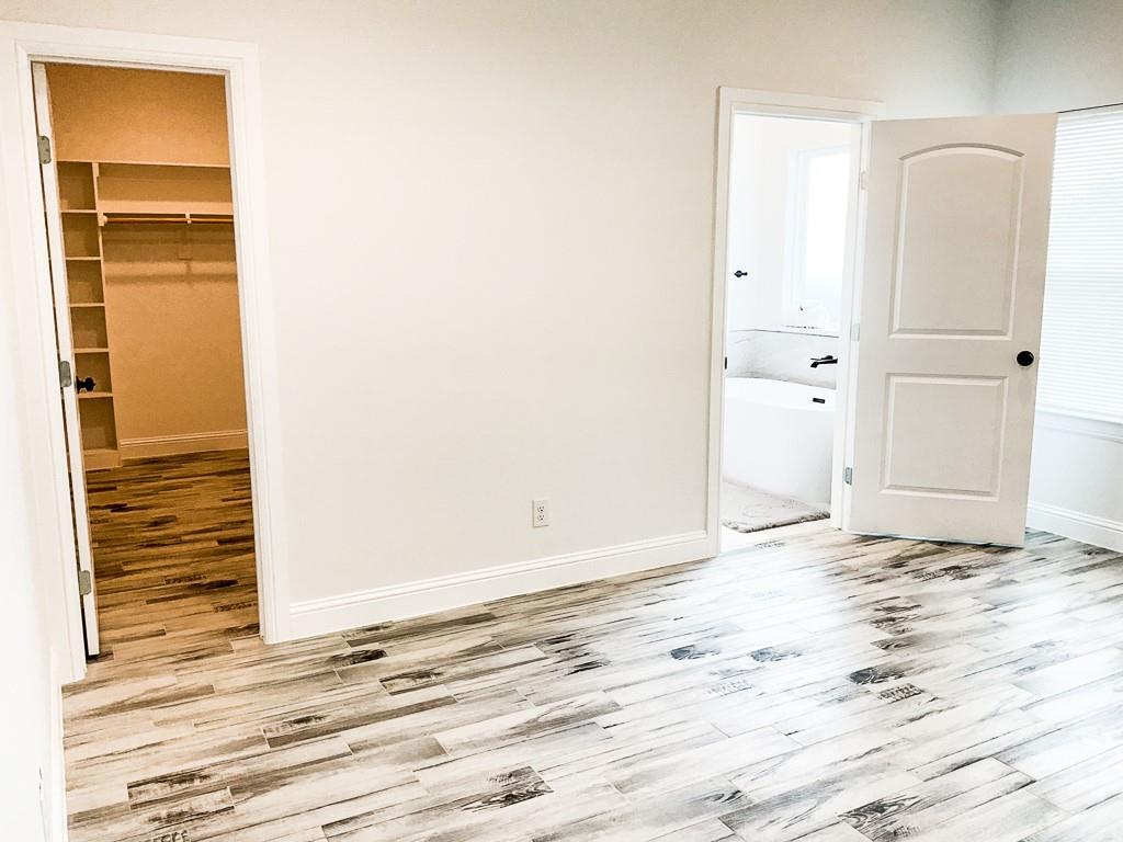 201 Bluff Court Godley, TX 76044 - Photo 9 of 17 a view of a room with wooden floor and closet