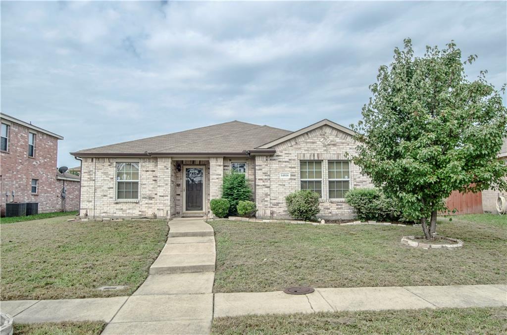 a front view of a house with a yard and potted plants