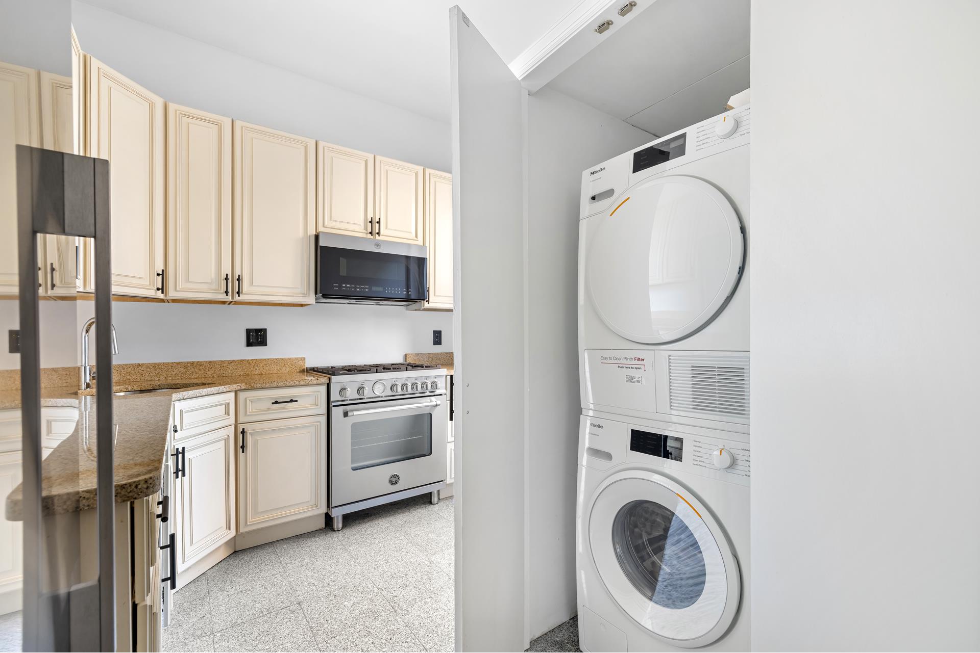340 West 86th Street, Unit 11C Manhattan, NY 10024 - Photo 6 of 15 a kitchen with stainless steel appliances a white cabinet a oven and a white cabinets