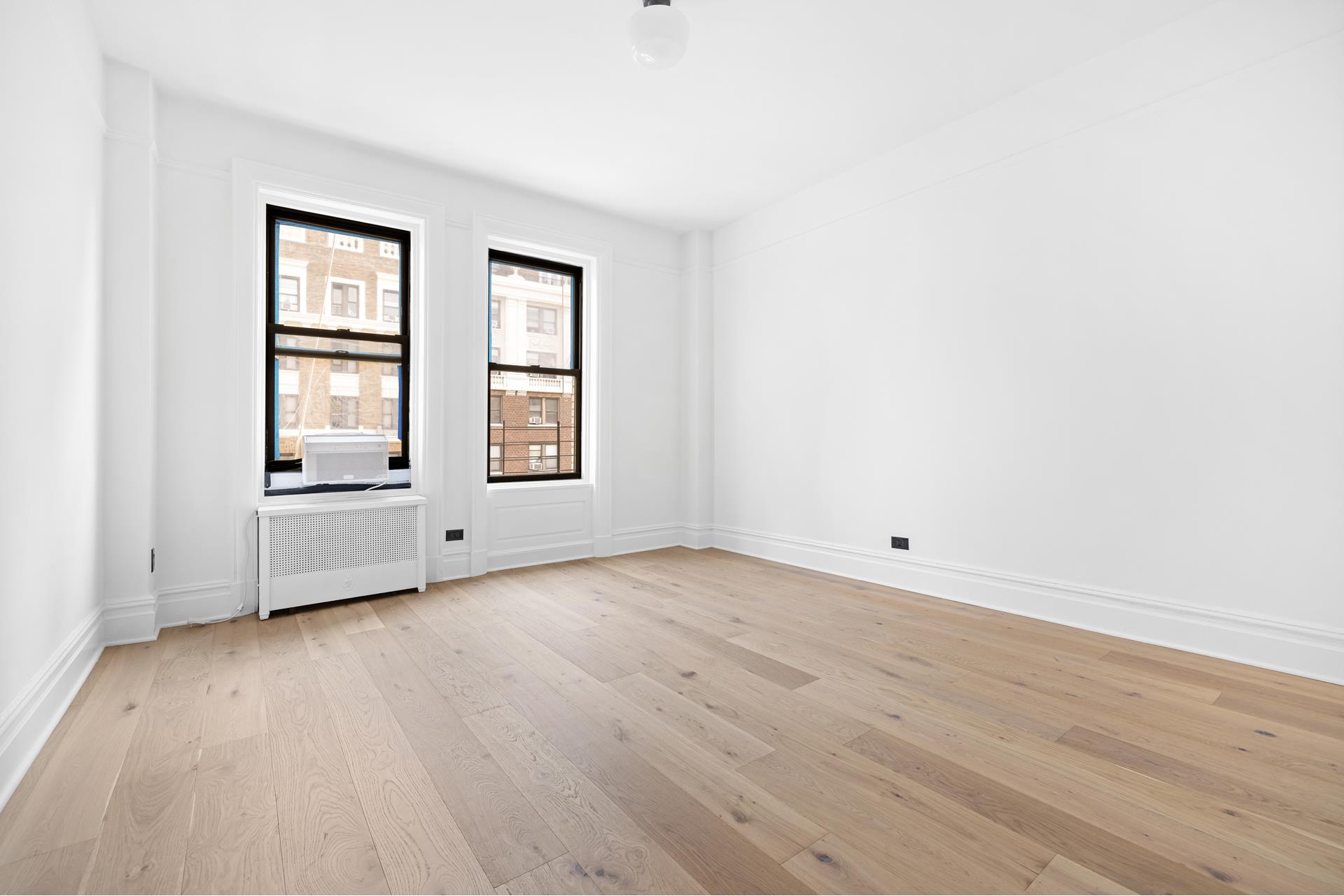 340 West 86th Street, Unit 11C Manhattan, NY 10024 - Photo 8 of 15 an empty room with wooden floor and windows