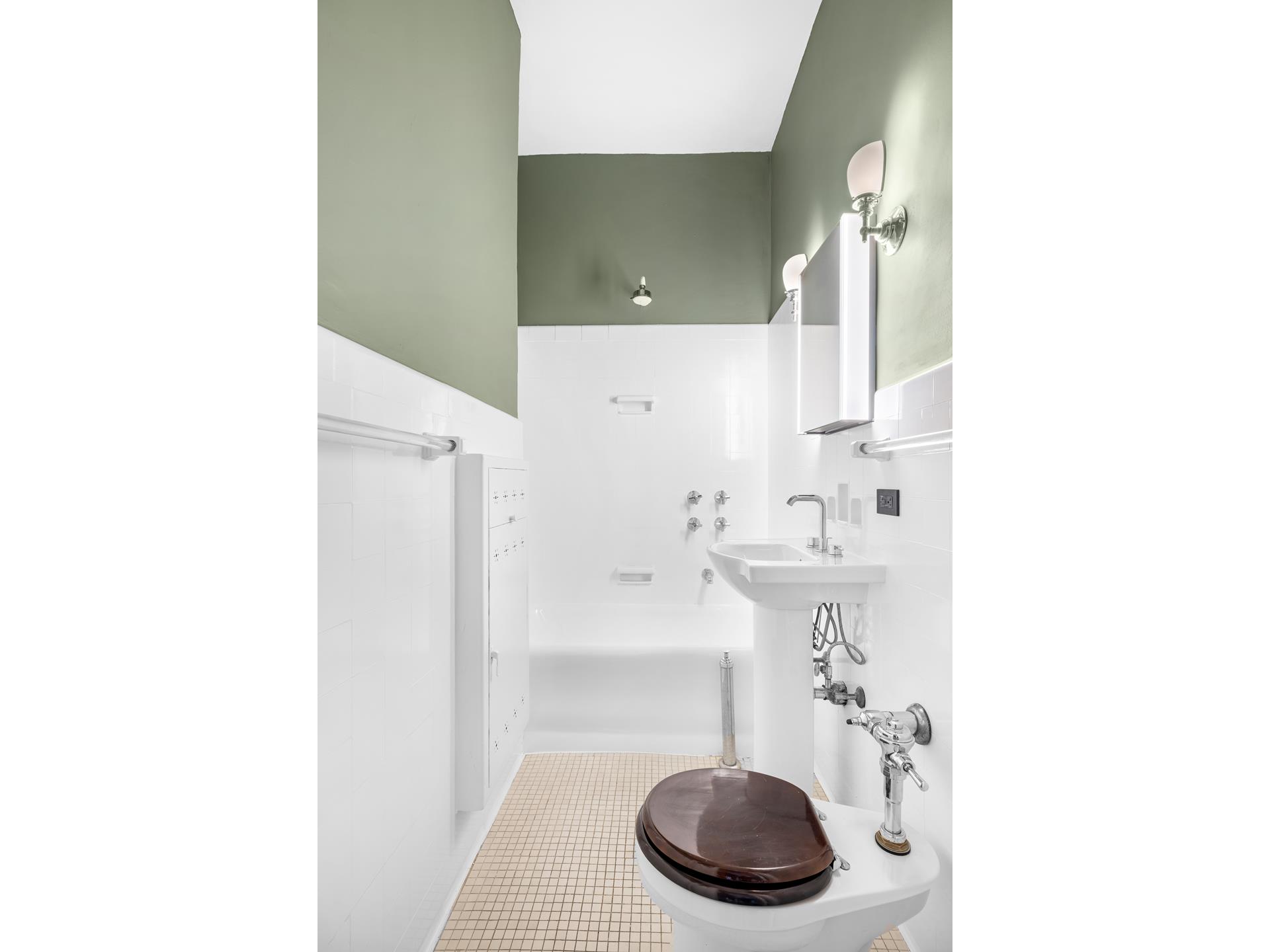 340 West 86th Street, Unit 11C Manhattan, NY 10024 - Photo 9 of 15 a bathroom with a sink and a mirror