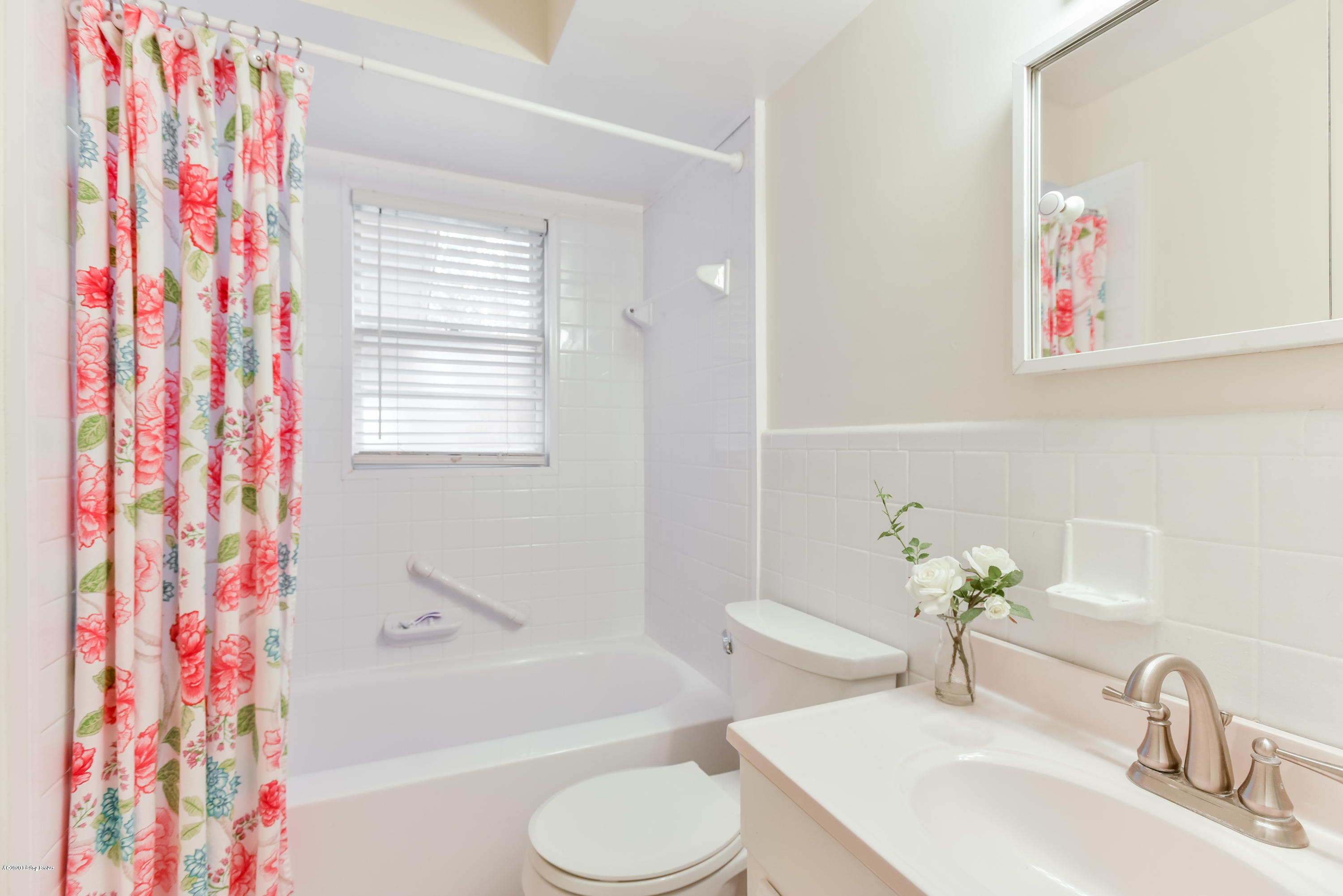 4705 Clarmar Road Louisville, KY 40299 - Photo 17 of 45 First floor full bath features white tile in the tub/shower and sink with vanity