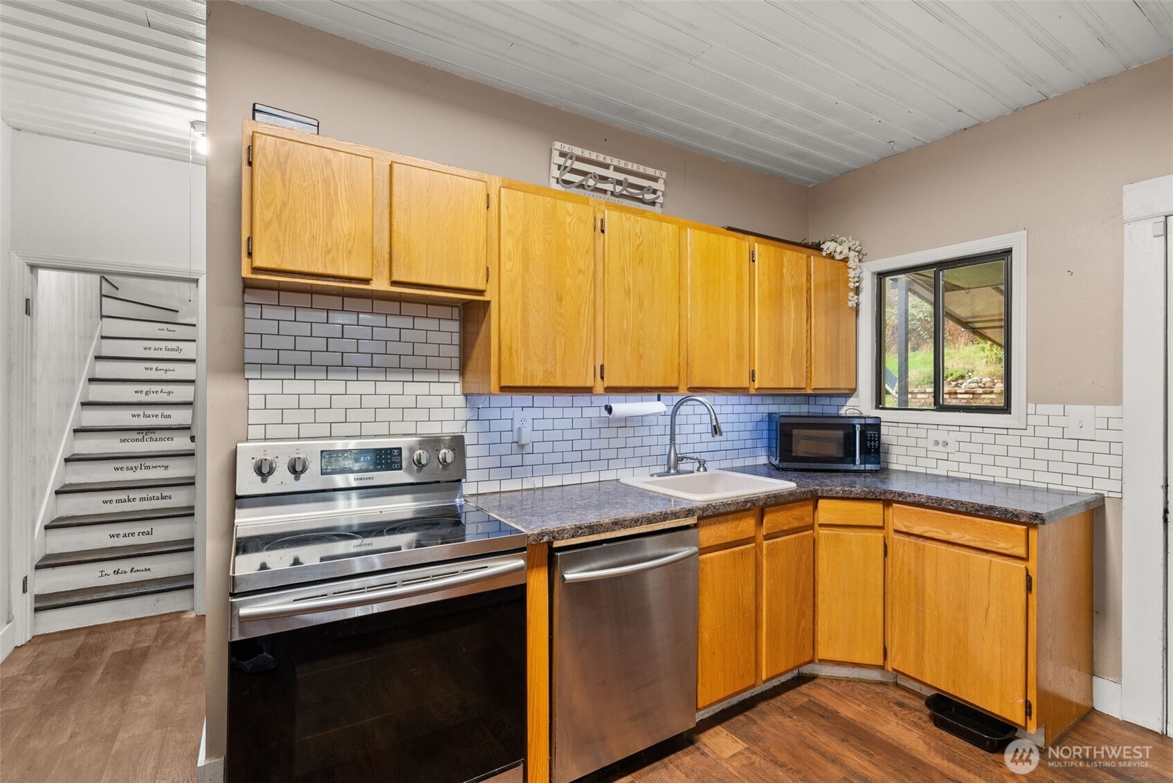 610 Barnhart Street Raymond, WA 98577 - Photo 16 of 34 a kitchen with a sink stove and cabinets