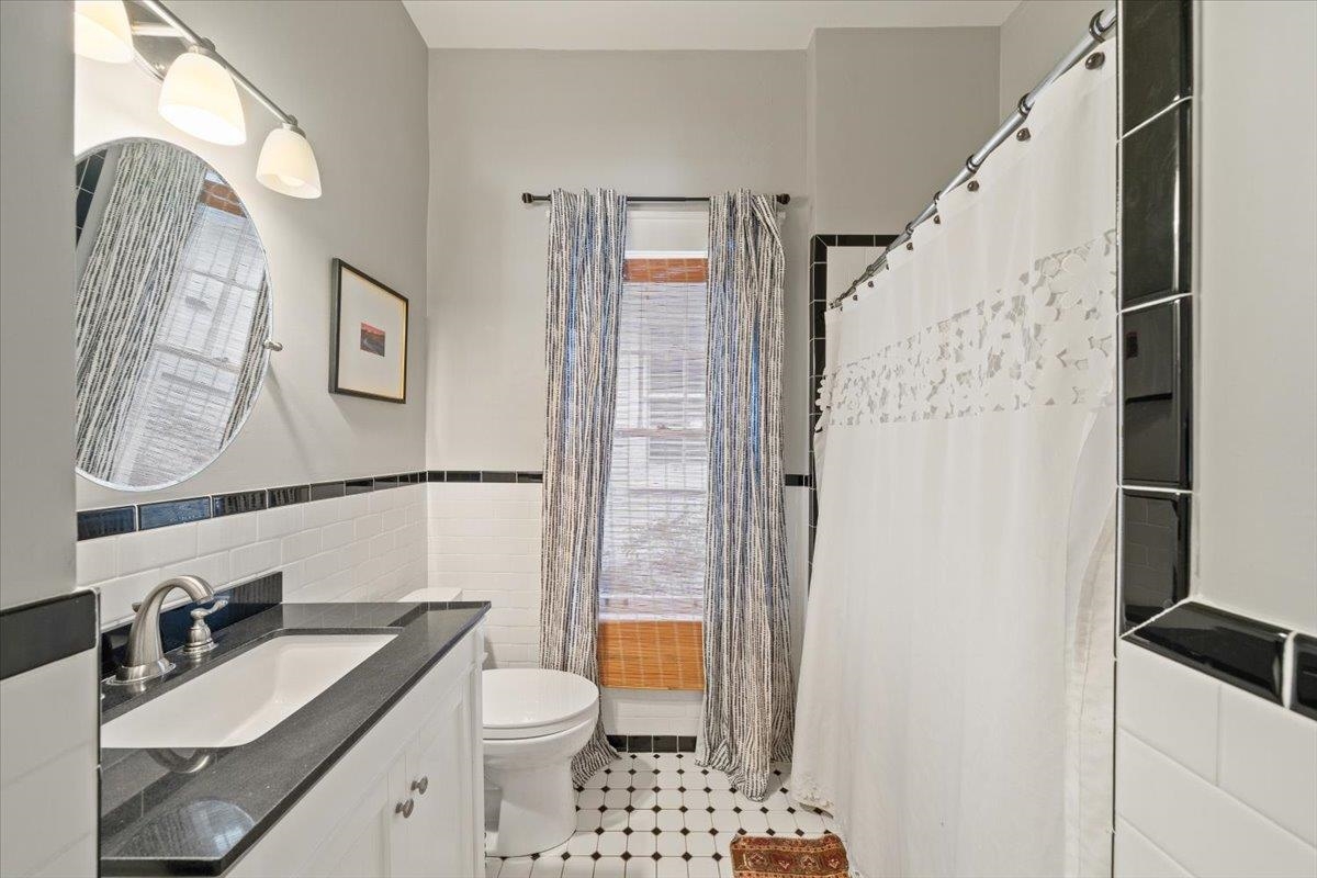 1937 Harbert Avenue Memphis, TN 38104 - Photo 20 of 32 a bathroom with a granite countertop sink toilet and shower
