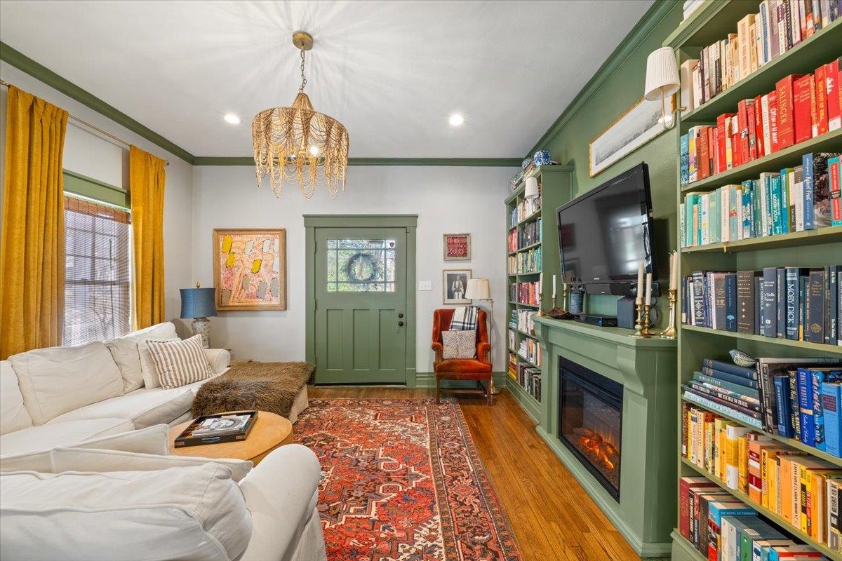 1937 Harbert Avenue Memphis, TN 38104 - Photo 5 of 32 a living room with fireplace furniture and a book shelf
