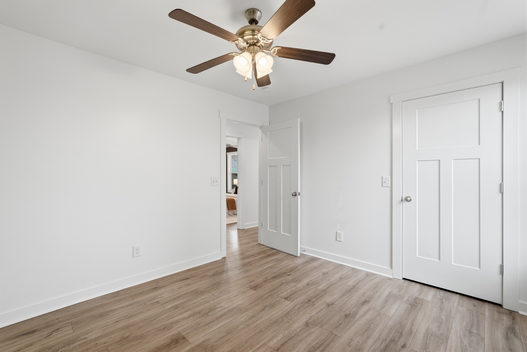 113 11th Avenue West Springfield, TN 37172 - Photo 16 of 28 an empty room with wooden floor and ceiling fan