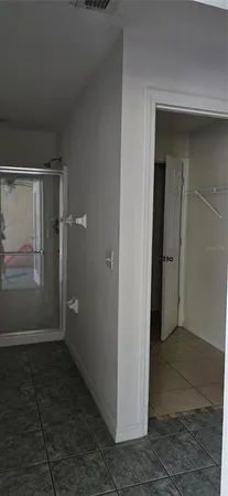 an empty room with an entrance to other room