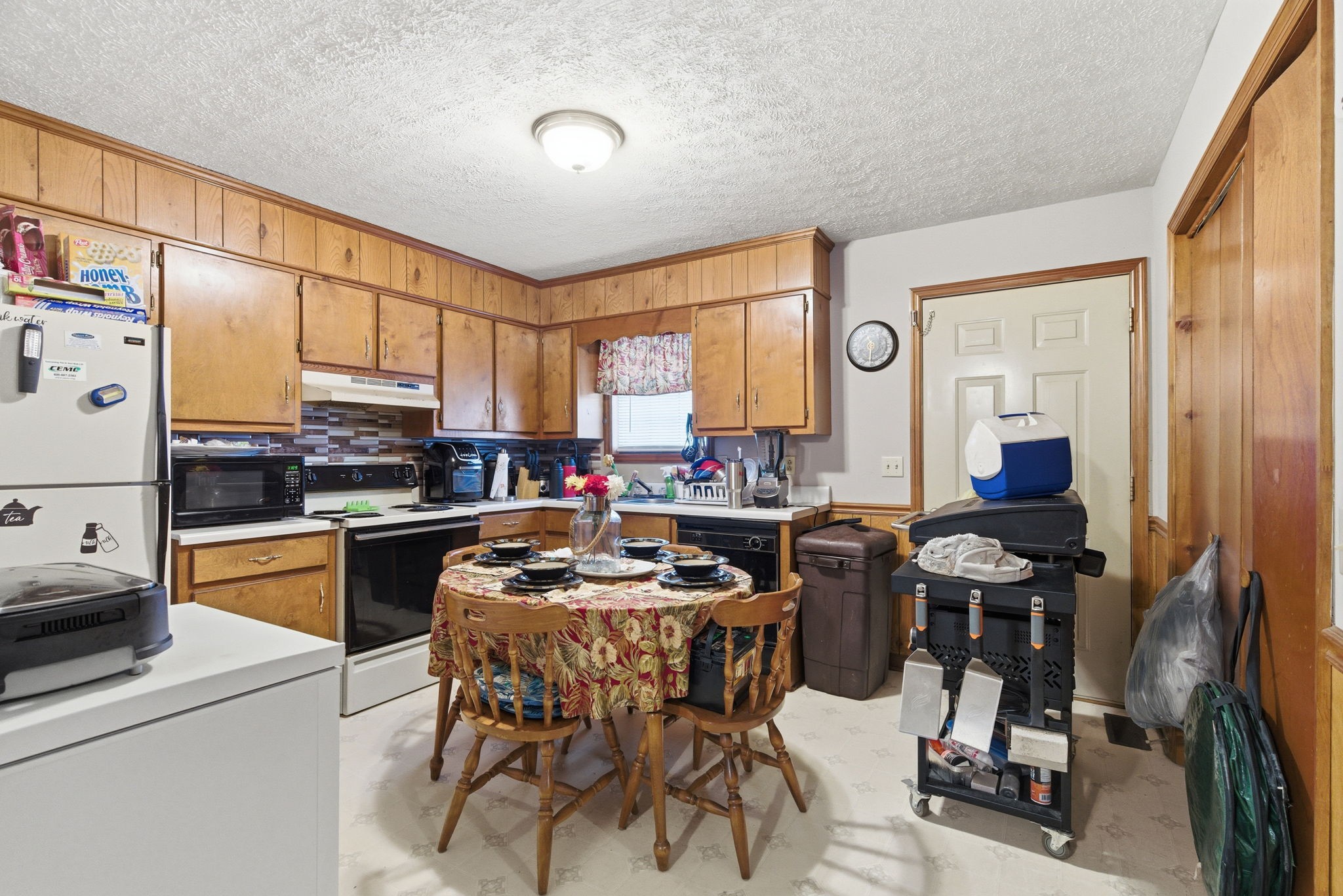 109 Gayla Court Portland, TN 37148 - Photo 34 of 48 a kitchen with a table chairs refrigerator and cabinets