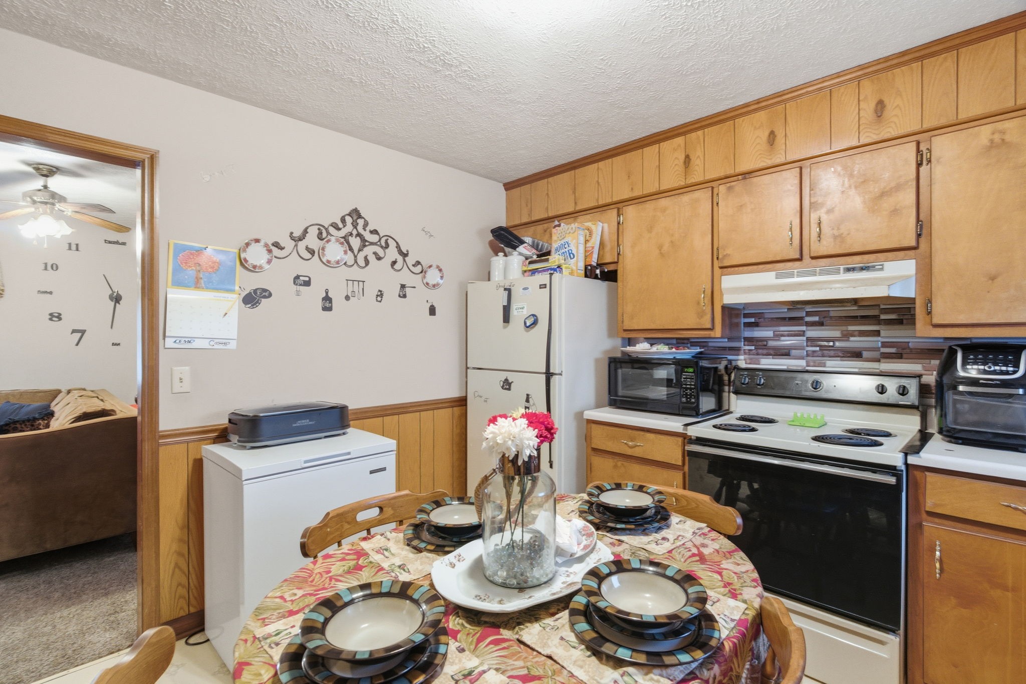 109 Gayla Court Portland, TN 37148 - Photo 35 of 48 a kitchen with stainless steel appliances kitchen island granite countertop a table and chairs in it