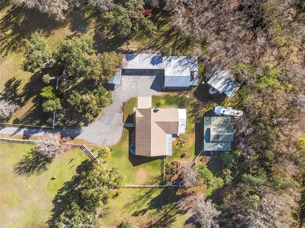 a view of a patio with table and chairs potted plants with wooden floor and fence