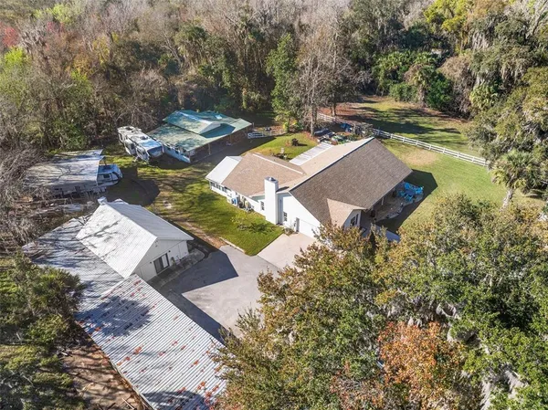 front view of a house with a yard and trees