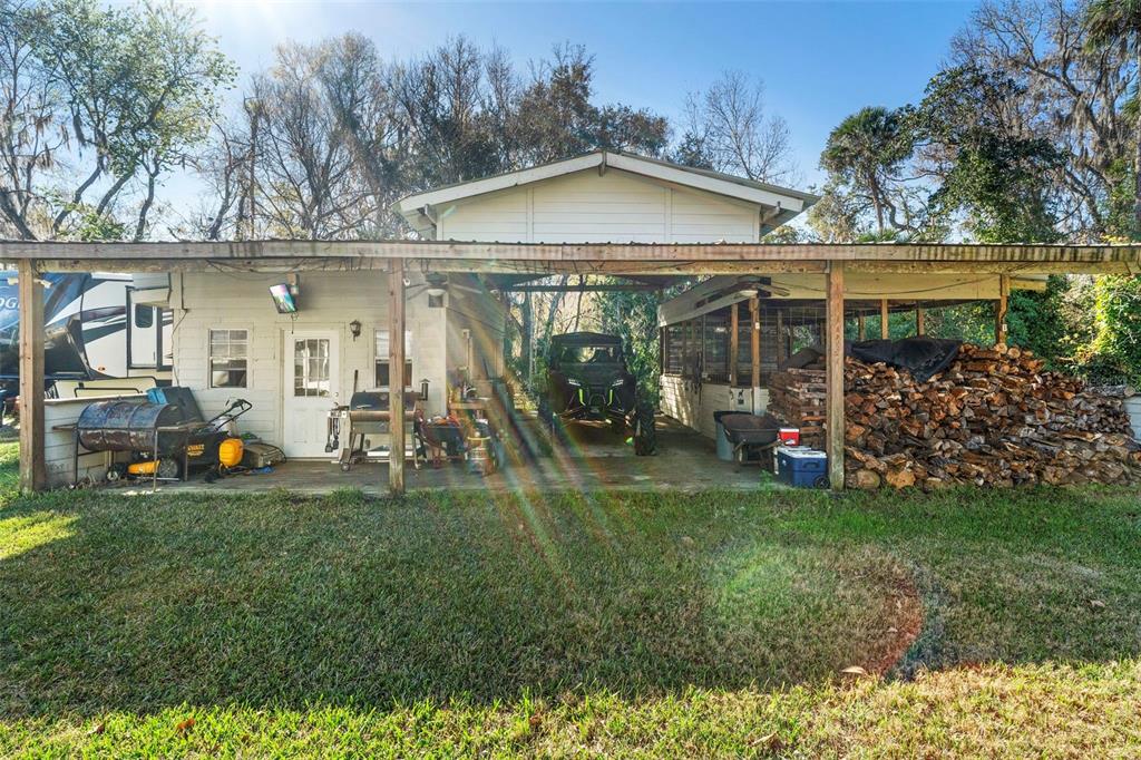 3080 Ragis Road Edgewater, FL 32132 - Photo 19 of 86 a view of a chair and table in backyard of the house