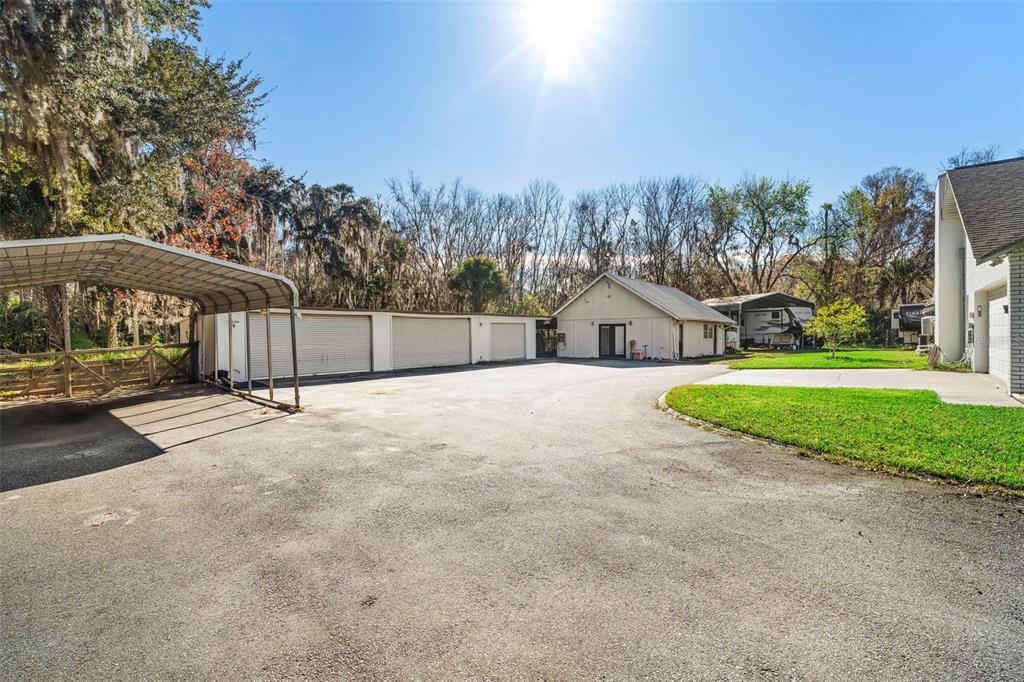 3080 Ragis Road Edgewater, FL 32132 - Photo 27 of 86 a view of a house with a big yard and large tree