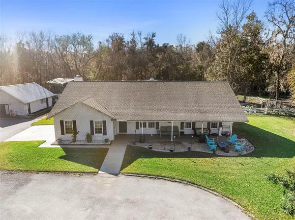 a view of house and outdoor space with swimming pool and outdoor seating