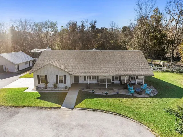 a view of house and outdoor space with swimming pool and outdoor seating