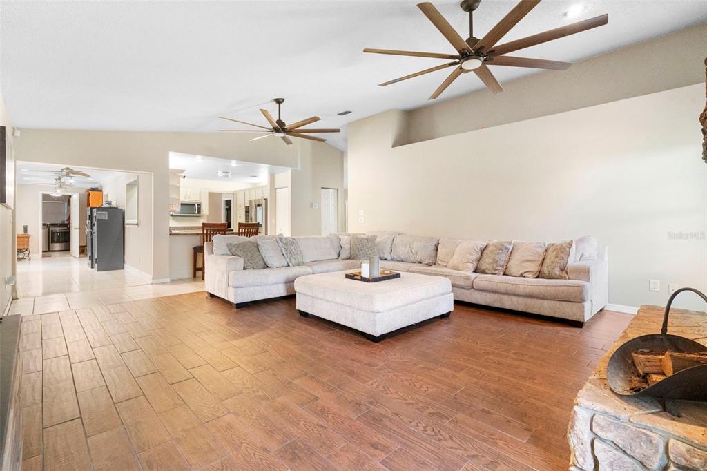 3080 Ragis Road Edgewater, FL 32132 - Photo 34 of 86 a living room with furniture and a chandelier