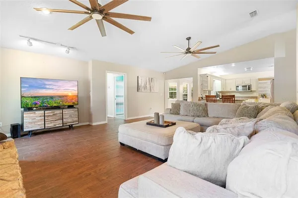 a view of livingroom with hardwood floor and ceiling fan