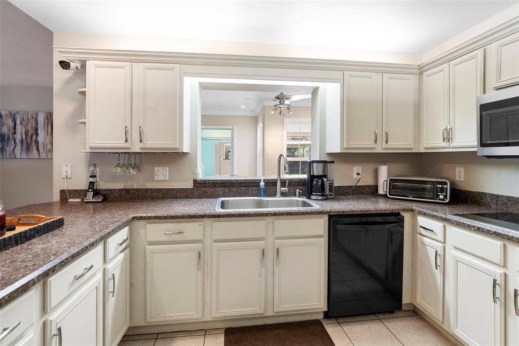 3080 Ragis Road Edgewater, FL 32132 - Photo 38 of 86 a kitchen with cabinets appliances a sink and a counter top space