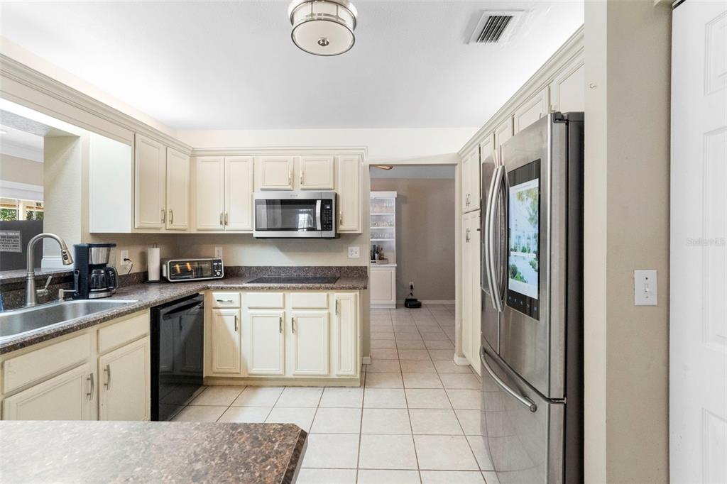3080 Ragis Road Edgewater, FL 32132 - Photo 41 of 86 a kitchen with stainless steel appliances granite countertop a refrigerator sink and cabinets