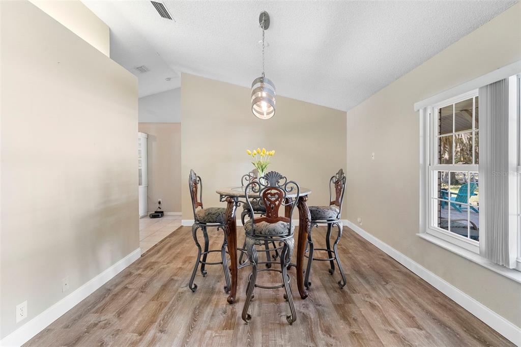 3080 Ragis Road Edgewater, FL 32132 - Photo 44 of 86 a view of a dining room with furniture window and wooden floor