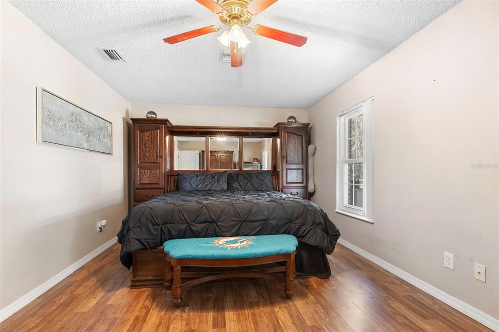 3080 Ragis Road Edgewater, FL 32132 - Photo 46 of 86 a bedroom with a bed and wooden floor