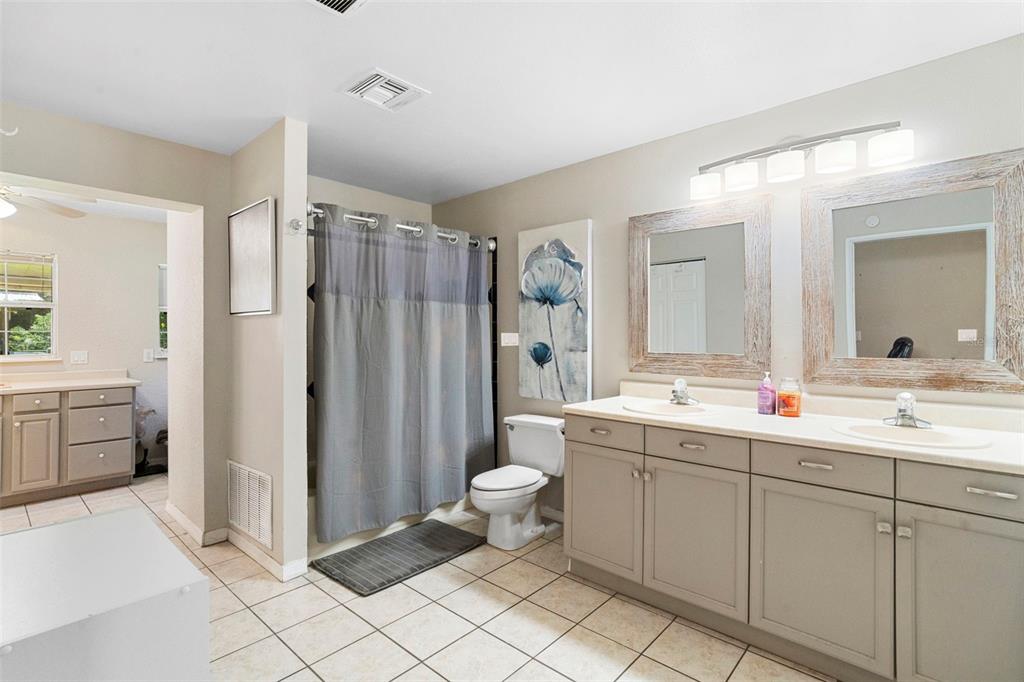 3080 Ragis Road Edgewater, FL 32132 - Photo 49 of 86 a bathroom with a double vanity sink mirror and toilet