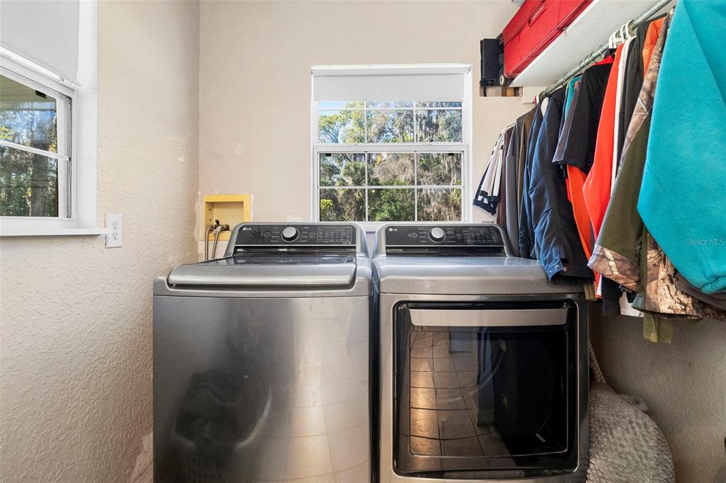 3080 Ragis Road Edgewater, FL 32132 - Photo 53 of 86 a view of walk in closet with clothes and shoes