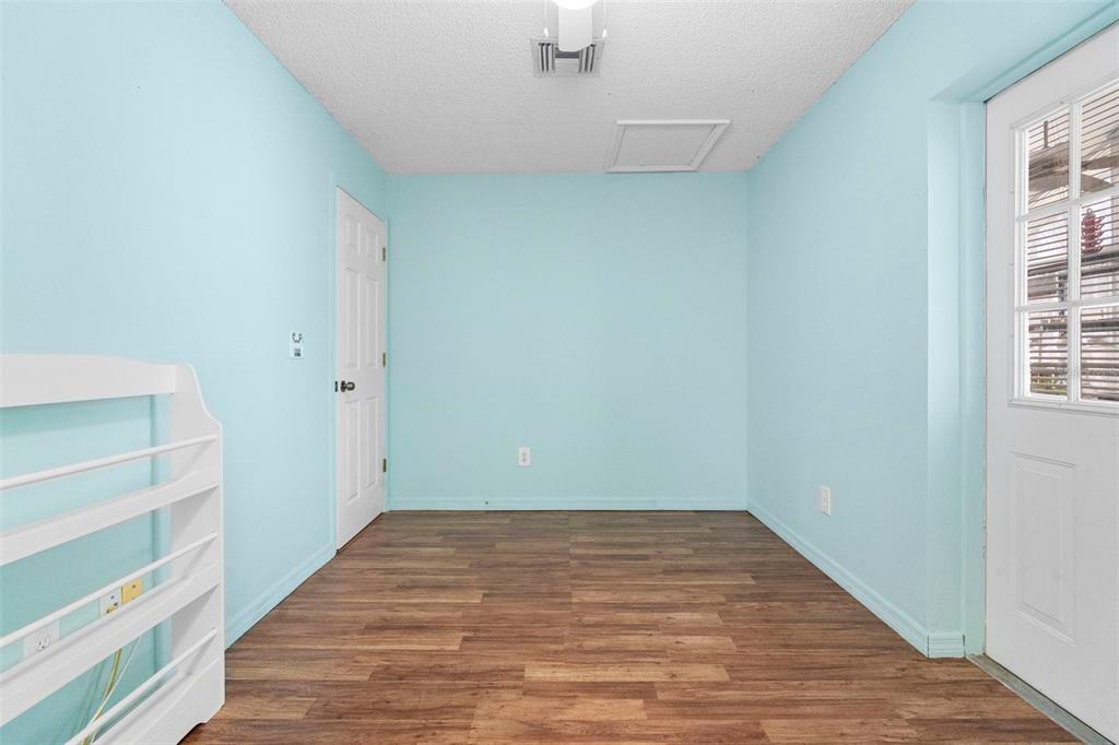 3080 Ragis Road Edgewater, FL 32132 - Photo 57 of 86 a view of room with window and wooden floor