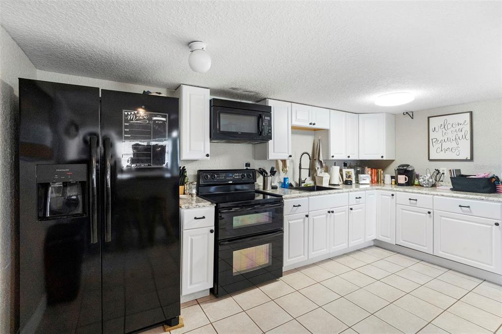 3080 Ragis Road Edgewater, FL 32132 - Photo 69 of 86 a kitchen with a refrigerator stove and sink